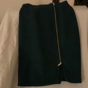 Hunter green wool pencil skirt with gold zipper just left of center